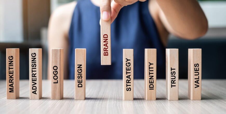 businesswoman-hand-placing-wooden-dominoes-with-te-2022-11-07-22-00-26-utc