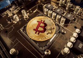 Gold Bit Coin BTC coins on the motherboard. Bitcoin is a worldwide cryptocurrency and digital payment system called the first decentralized digital currency.