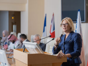 Mature female speaker in elegant suit making report