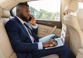 rich-afro-american-businessman-working-in-car-2022-12-16-07-24-47-utc